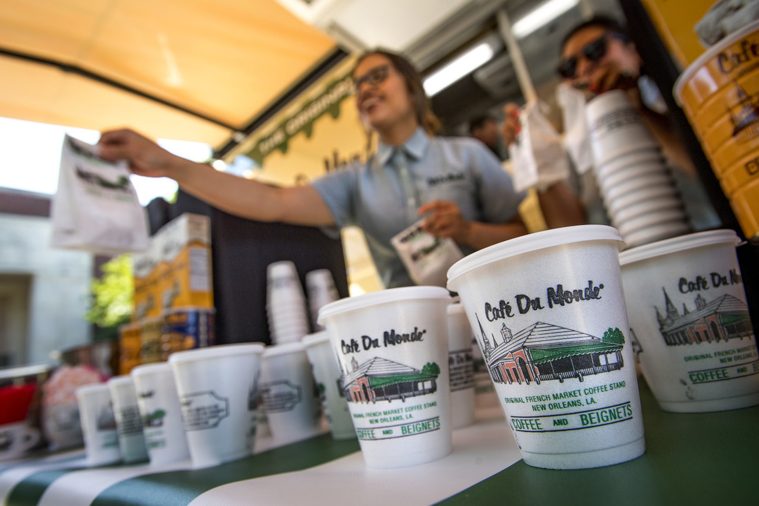 An employee hands out beignets and coffee fromt he Cafe Du Monde food truck.